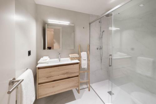 a white bathroom with a sink and a shower at The Miks Sur Mer 2 in Roses