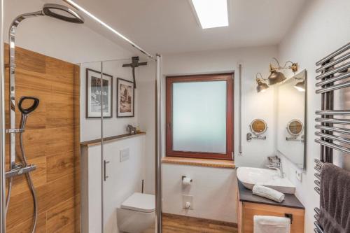 a bathroom with a toilet and a sink and a shower at Place 4you in Grafenau
