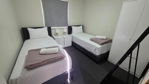 a small room with two beds and a balcony at The Prospect Executive Home in Prospect