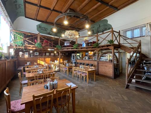 a dining room with wooden tables and chairs at Hotel U Branky in Stříbro