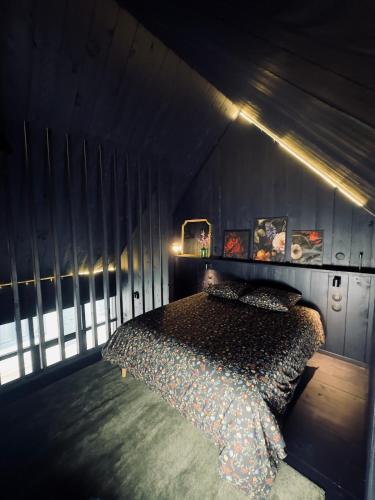 a bedroom with a bed in a dark room at Loft Cierp-Gaud in Cierp
