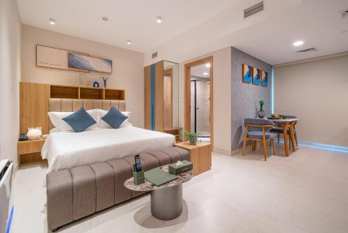 a bedroom with a bed and a table with a bottle on it at Tranquil Wellness Tower By Wellcube in Dubai