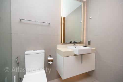 a bathroom with a white toilet and a sink at Oceanstone- 2BDR apartment in Ban Thalat Choeng Thale