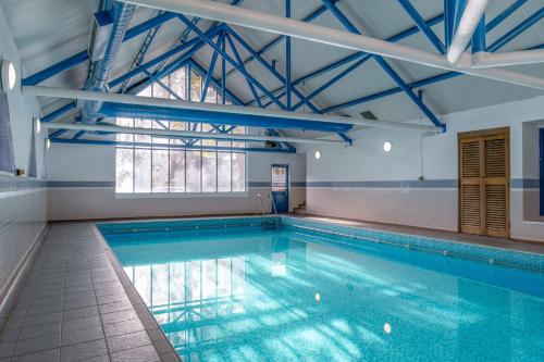 a swimming pool in a building with a large window at Carrington House Hotel in Bournemouth