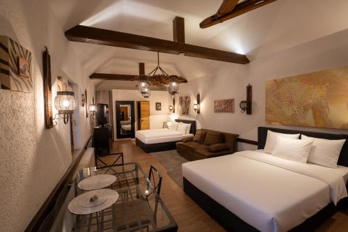a hotel room with a bed and a living room at Hotel am Hafen Leverkusen in Leverkusen