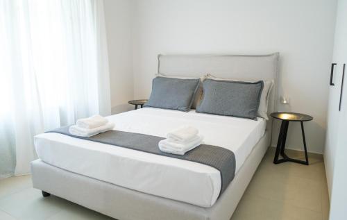 a bedroom with a white bed with towels on it at Villa Selina 3 - Etheras Properties in Kythira