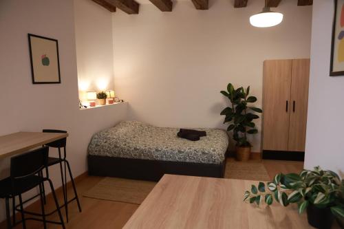 a room with a bed and a table in it at Les Écuries - Studio Hyper Centre & Bouffay in Nantes