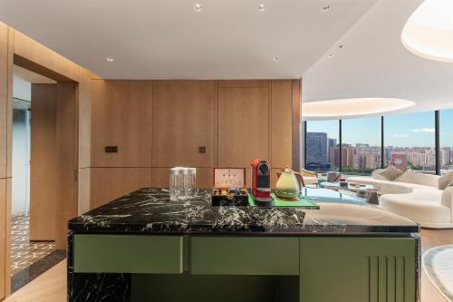 a kitchen with a tub and a living room at Hotel Indigo Chengdu Financial City by IHG in Chengdu