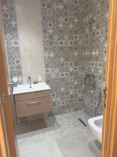 a bathroom with a shower and a sink and a toilet at La chebba plage in Chebba