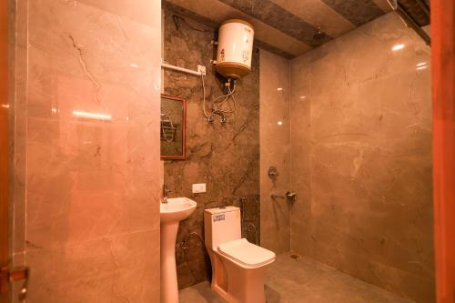 a bathroom with a toilet and a sink at The Himvan Stay in Mundaghat 