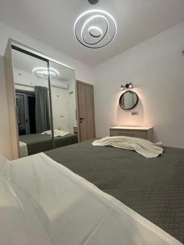 a bedroom with a large bed and a mirror at Drios Hillhouse II in Drios