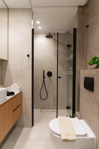 un bagno con doccia, wc e lavandino di Opus Boutique Apartment a Alexandroupoli