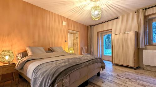 a bedroom with a large bed in a room at La Ferme du Château in Beire-le-Châtel