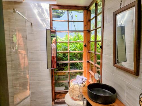 a bathroom with a window and a sink at ZenCapeTown Forest Retreat in Cape Town