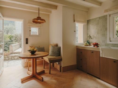 a kitchen with a table and a sink and a table at La Residencia, A Belmond Hotel, Mallorca in Deia