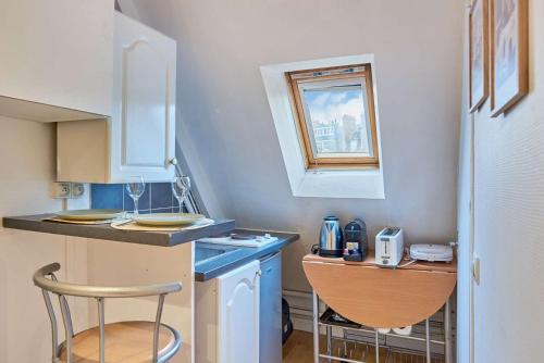 a small kitchen with a counter and a sink at Charming Studio Arc de Triomphe Monceau in Paris