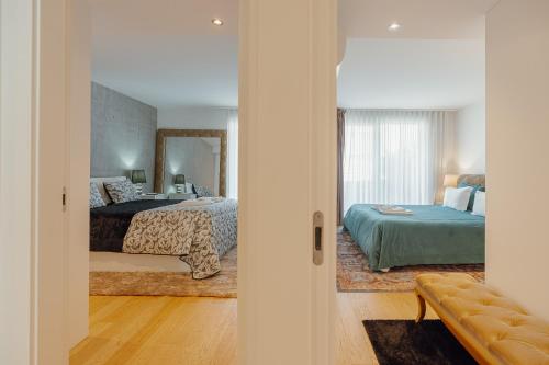 a bedroom with two beds and a mirror at Luxury Beach House by Hosty in Canidelo
