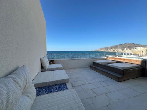 a balcony with benches and a view of the ocean at Cielomare Residence Diffuso in Trapani