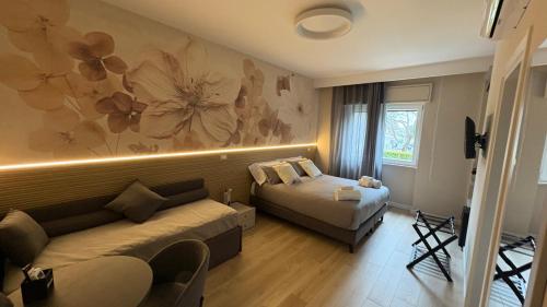 a living room with a couch and a bed at Affittacamere Nonna Maria in Foggia