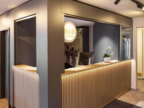 an office with a reception desk in a lobby at B&B HOTEL Gießen-Linden in Gießen