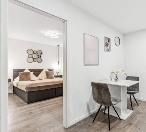 a bedroom with a bed and a table and a mirror at Prime Host perfect room in Karlsruhe