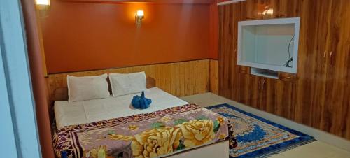 a bedroom with a bed and a tv in it at indrapuri homestay in Darjeeling