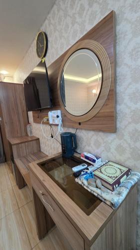 a bathroom with a sink with a mirror on it at Al-Mahasen Hotel in An Najaf