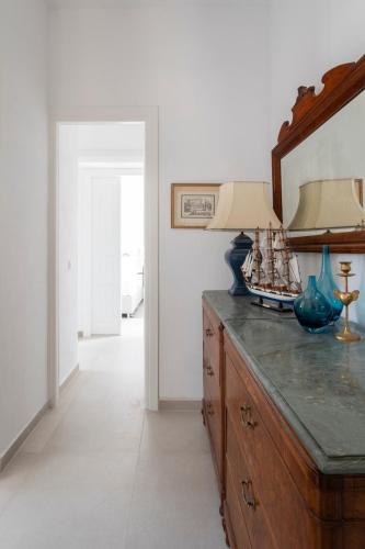 a room with a wooden dresser with a mirror at Eagle House Spetses 4 bedrooms in Spetses