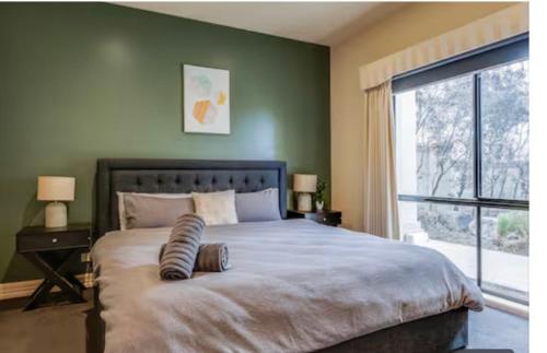 a bedroom with a large bed and a window at Home in Highton in Highton