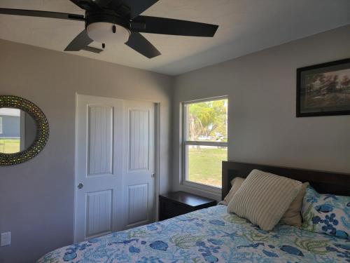 a bedroom with a bed and a ceiling fan at Manatee River Bungalows - 2 in Bradenton