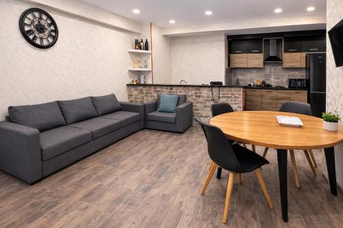 a living room with a couch and a table at Home Inn Apartments Your house Jikia-Central Tbilisi in Tbilisi City