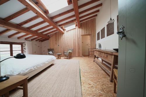 a bedroom with a bed and a desk in a room at Le Presbytère de Bugarach in Bugarach