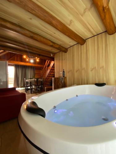 a large bath tub in a room with a table at Cabana Do Lago in Joinville