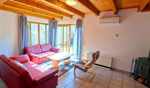 a living room with a couch and a table at Haus 23 Natur Ferienpark - Gemütlicher Urlaubsort für entspannte Tage im Grünen und in der Nähe von den Externsteinen in Nieheim