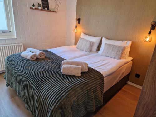 a bedroom with a bed with towels on it at Puur 38 in Simpelveld