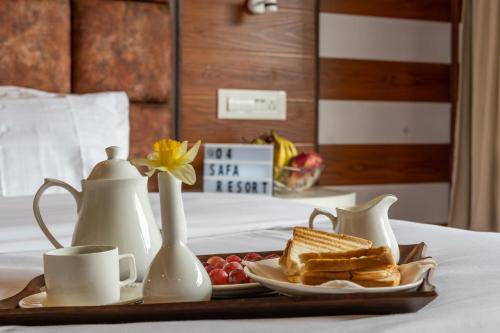 a breakfast tray with toast and fruit on a bed at Fimi hotel aru valley pahalgam in Ārau