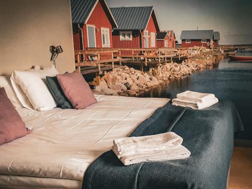 a large bed with towels on it next to a house at Halltorps Gästgiveri in Borgholm