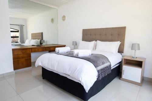 a bedroom with a large bed and a sink at Windsor Place by First Private Stays in Margate