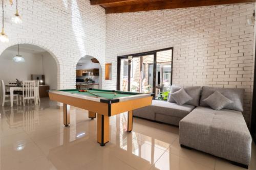 a living room with a pool table and a couch at Windsor Place by First Private Stays in Margate