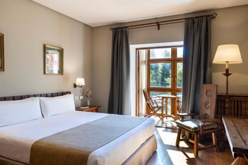 a hotel room with a bed and a window at Parador de Fuente Dé in Fuente Dé