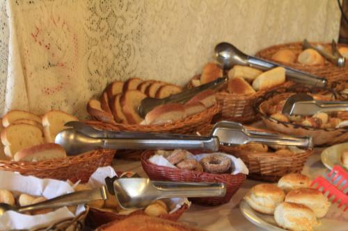 a table topped with baskets of bread and pastries at Hotel Luxor in Ouro Preto