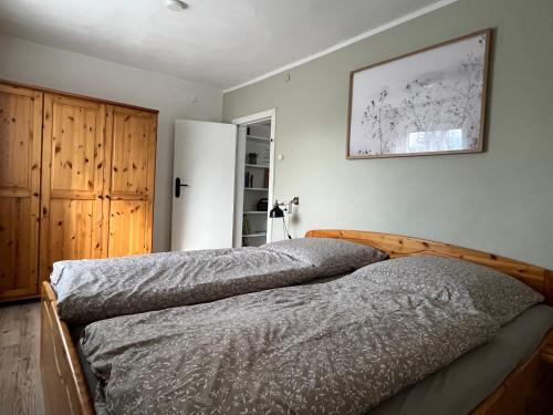 a bedroom with two beds and a picture on the wall at house46-1 in Hohen Neuendorf