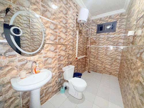 Un baño con lavabo, inodoro y ducha. en House & Food, en Thiès