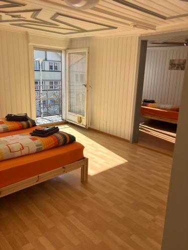 a large room with a bed and a large window at 22 - Gästehaus Erika - Hundwil - Appenzellerland in Hundwil