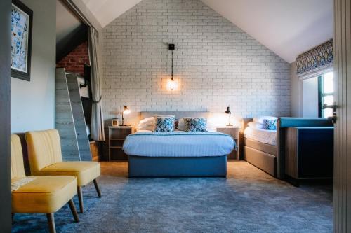 a bedroom with two beds and a chair at Lisnacurran Country House in Lisburn