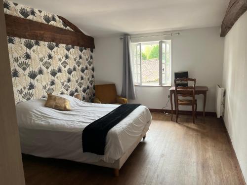 a bedroom with a large bed with a wall at Chez PRESSOIRS in Mesnac