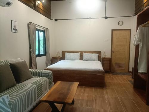 a living room with a bed and a couch at Than Khao Nature Resort and Homestay - Krabi Noi in Krabi