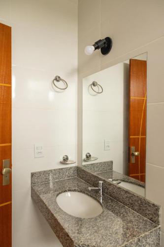 a bathroom with a sink and a mirror at Hotel Primavera Palace in Salinas