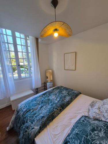 a bedroom with a bed and a large window at Candy house in Salies-de-Béarn