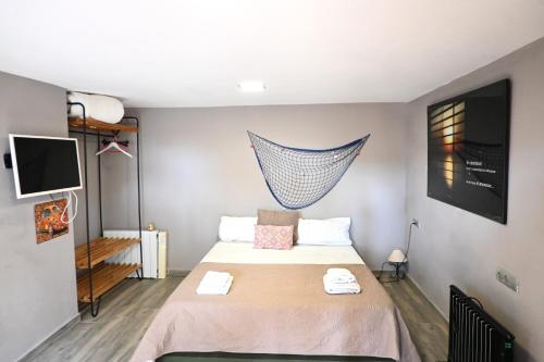 a bedroom with a bed with a net on the wall at Homenfun Costa Brava Begur Villa in Begur